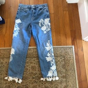 Blue mom jeans with white flowered embroidery